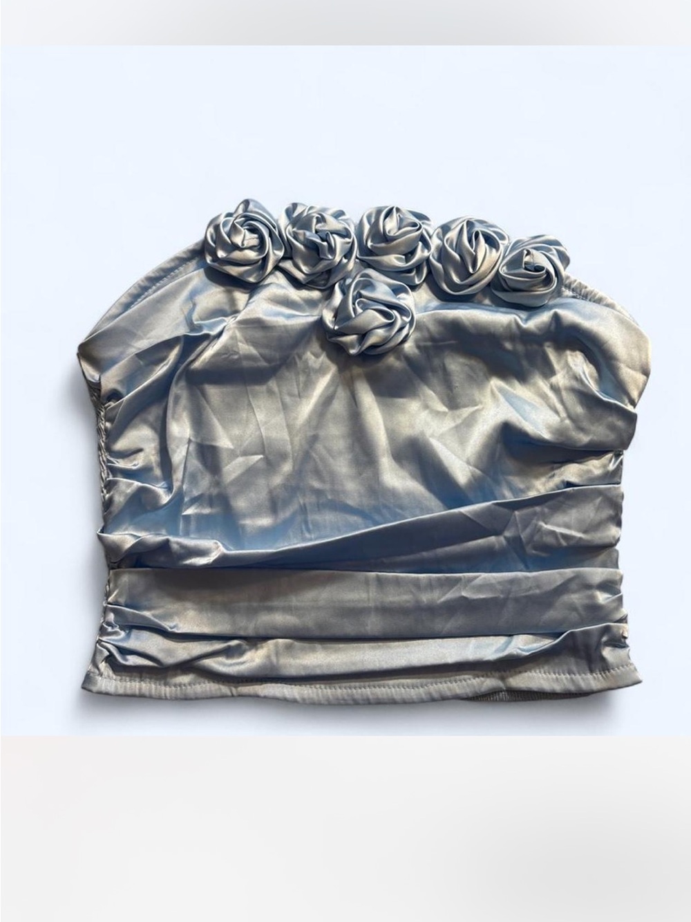 Blue satin strapless crop top with rosettes.